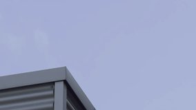 Top of a metal technical bild against the backdrop of floating clouds in summer - Powered by Shutterstock - Get 15% off with code: PIKWIZARD15