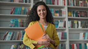 Welcoming Latino Arabian woman gesturing inviting in library happy female student girl learning study education calling join community bookstore team club discussion academy university college learner - Powered by Shutterstock - Get 15% off with code: PIKWIZARD15