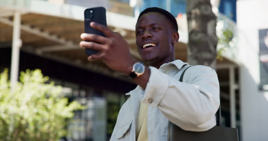 Phone, streaming and talking or black man in city for video call, social media vlogger and contact. Networking, college content creator and influencer with person outdoor for university memory