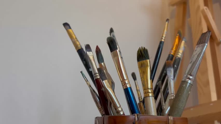 Close up artistic paintbrush in artist studio slow motion. Brushes for oil and watercolor painting
