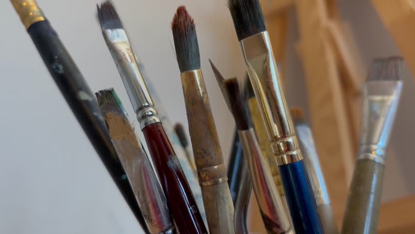 Close up artistic paintbrush in artist studio slow motion. Brushes for oil and watercolor painting