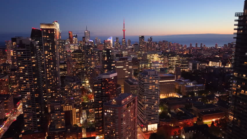 Drone view of the evening Toronto skyline. City lights. Downtown skyscrapers viewed from above. Toronto, Ontario, Canada.
