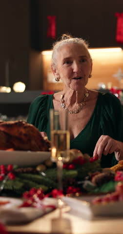 Christmas, dinner party or woman laugh at table, funny conversation or sharing meal for holiday celebration. Festive bonding, speaking or senior person with family in home, food or joke for reunion