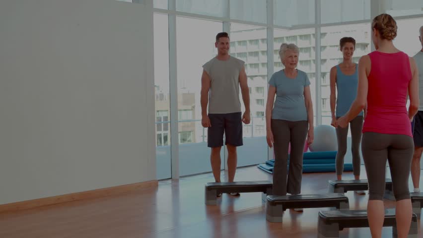 Instructor cueing and leading class stepping on steps while animated charts overlaying fitness data. Participants, workout, coach, studio, cityscape, coordination, balance