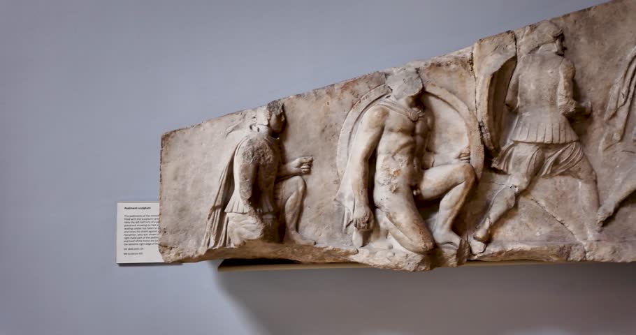 Close-up view of the high-relief battle frieze from the Nereid Monument, showcasing ancient Greek warriors in combat, exhibited at the British Museum in London