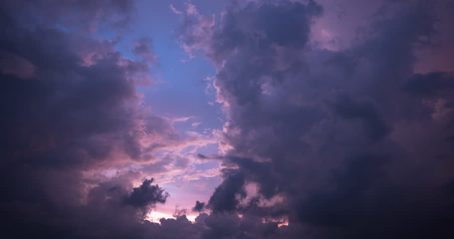 Timelapse of colorful dusk sky with thick clouds