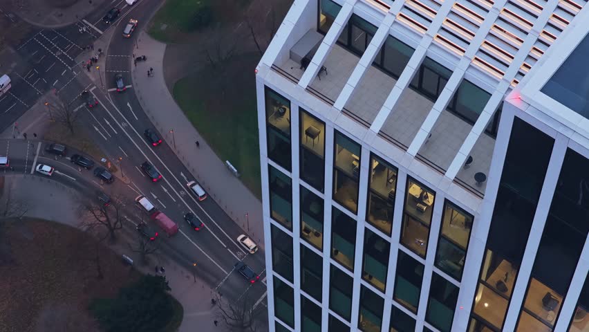 High angle view of TaunusTurm modern skyscraper in Frankfurt financial district. City traffic flowing on the streets below during the evening