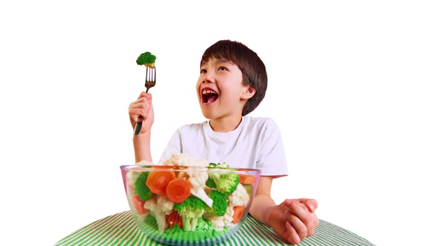 Quirky animation. Excited boy at table holding fork with broccoli on white backdrop with HEALTHY and YUMMY words swirl around. Concept of kids healthy visuals, veggie promos and family food branding.