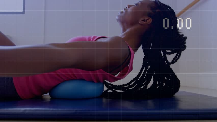 Woman doing back extension on blue mat with bolster, timer starting, line-graph tracking for rehab. Fitness, stretching, supine, thoracic, posture, balance, home