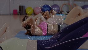 Women following class cue, crunching on blue mats in fitness class, globe overlay pulsing over abs. Group, studio, gym, core, routine, teamwork, vibrant - Powered by Shutterstock - Get 15% off with code: PIKWIZARD15