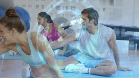 Front woman reaching and twisting on blue mats while light blue HUD appearing guiding fitness form. Turquoise, studio, group, stretch, rotation, stability, balls - Powered by Shutterstock - Get 15% off with code: PIKWIZARD15