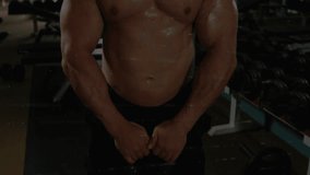 Male lifter gripping 20 KG kettlebell in gym, lifting, tracking metrics with HUD charts growing. Fitness, bodybuilding, muscle, sweat, data, overlays, candlestick - Powered by Shutterstock - Get 15% off with code: PIKWIZARD15