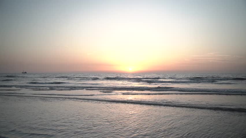 fishing boat at sea at sunset