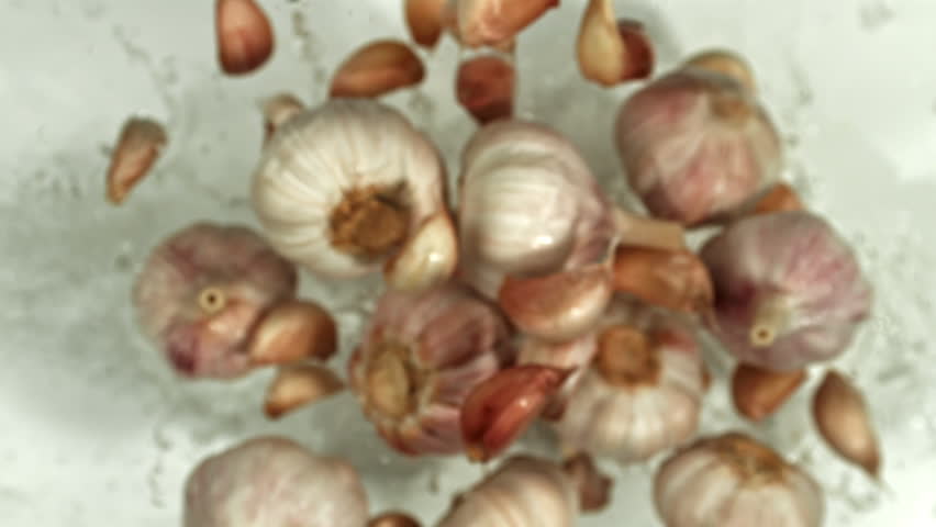 Garlic flying up on a light background. Filmed on a high-speed camera at 1000 fps. High quality FullHD footage