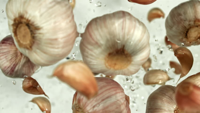 Garlic flying up on a light background. Filmed on a high-speed camera at 1000 fps. High quality FullHD footage