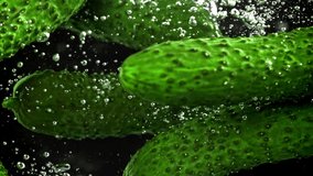 Cucumbers falling under water on a black background. Filmed on a high-speed camera at 1000 fps. High quality FullHD footage - Powered by Shutterstock - Get 15% off with code: PIKWIZARD15