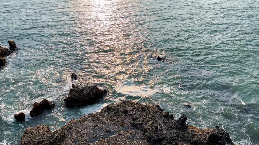 High Angle View of Ocean Waves Crashing on Rocky Shore