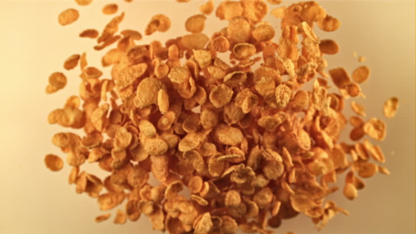 Cornflakes flying upwards on a light background. Filmed on a high-speed camera at 1000 fps. High quality FullHD footage