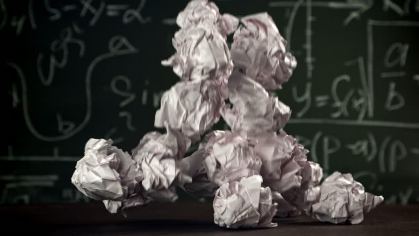 Crumpled paper falls on the school desk. Filmed on a high-speed camera at 1000 fps. High quality FullHD footage