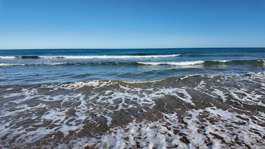 Cullera beach coastline with waves breaking on sand