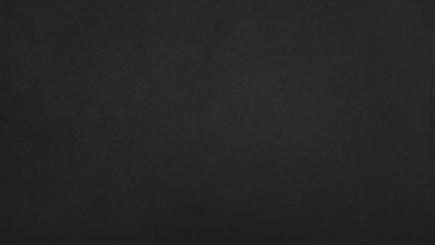 Wide vertical rip in real black paper exposes a large frame gap as both paper sides slide out.