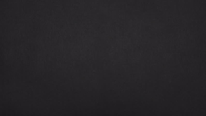 Vertical tear in real black paper slides out and leaves a bold black paper frame around the image.
