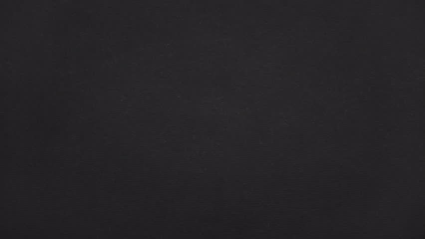 Diagonal strip torn from real black paper opens a tall paper gap for titles or footage in the center.