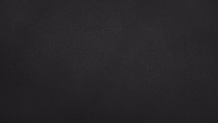 Second variation of real black paper torn diagonally and sliding off for a fresh handmade paper transition.