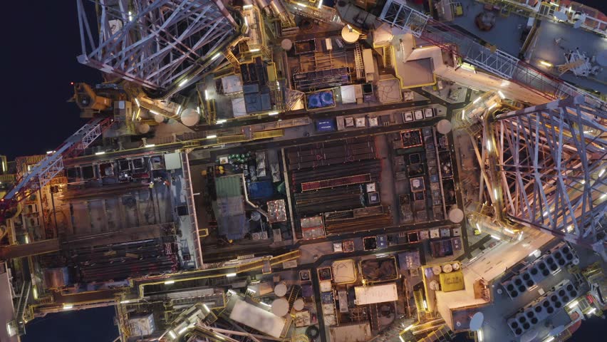 Aerial top view of offshore jack up rig and offshore platform during sunset for oil and gas exploration and production. 
