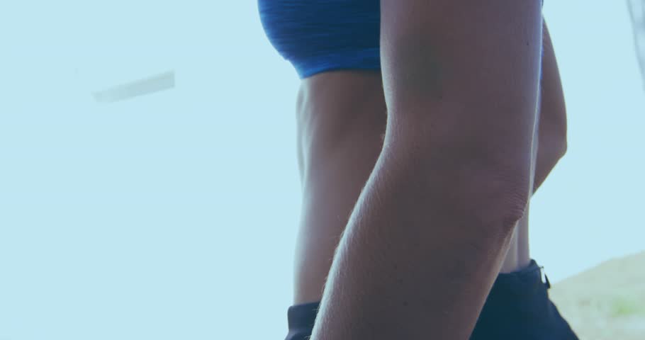 Female torso breathing, Flash Sale banner sliding from right, covering midriff, promoting fitness. Athlete, activewear, outdoor, sunny, vibrant, physique, promo