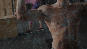 Shirtless man holding weights at shoulder pressing overhead for strength, gym mirror showing woman. Athlete, dumbbell, training, fitness, duo, studio, boxes - Powered by Shutterstock - Get 15% off with code: PIKWIZARD15