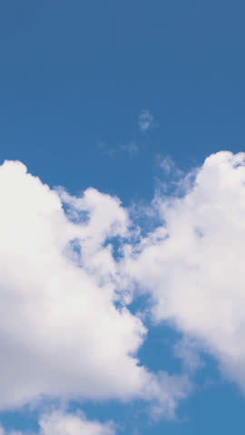 A tranquil time-lapse from an airplane window shows soft white clouds drifting over a deep blue sky, evoking calm aerial serenity—ideal for travel, relaxation, or background visuals.