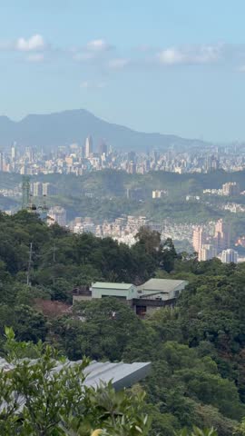 Panorama view of the Taipei city skyline as seen from the area of Maokong in the hills above the city - explore Taiwan