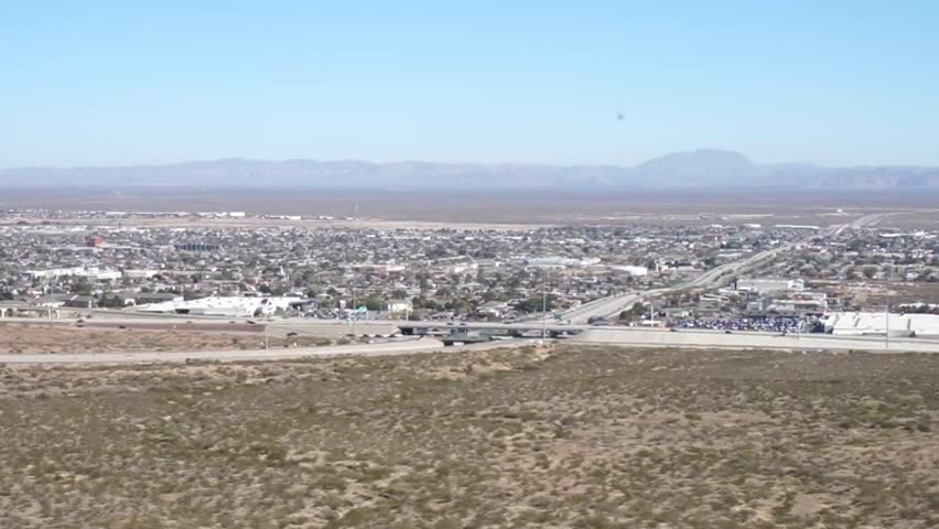 El Paso, Texas, USA city skyline from the desert with traffic on the highway and mountains behind in 2025