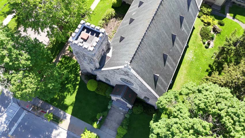 A church designed for those that practice the Episcopalian religion within the heart of a city, covered by lush green foliage.