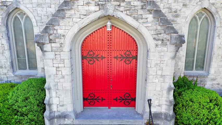 Rising up the front of a church facade until the surrounding city environment is revealed.