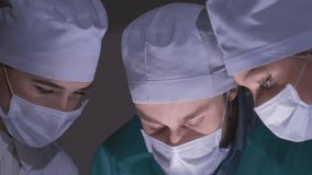 Surgical team of doctors and nurses performs an operation in a hospital operating room, showcasing advanced medical care, teamwork, and surgical procedures. - Powered by Shutterstock - Get 15% off with code: PIKWIZARD15