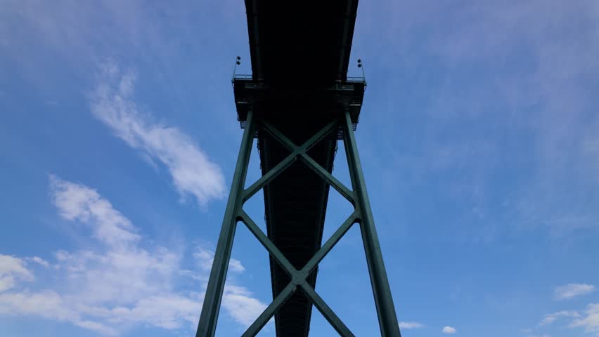 Gimbal close booming down shot of the Lions Gate Bridge pylon in Vancouver, British Columbia, Canada. 4K