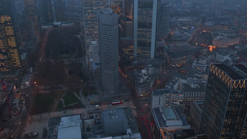 High angle view of Eurotower in Frankfurt am Main financial district in Germany. Modern skyscrapers, office buildings and street traffic at twilight