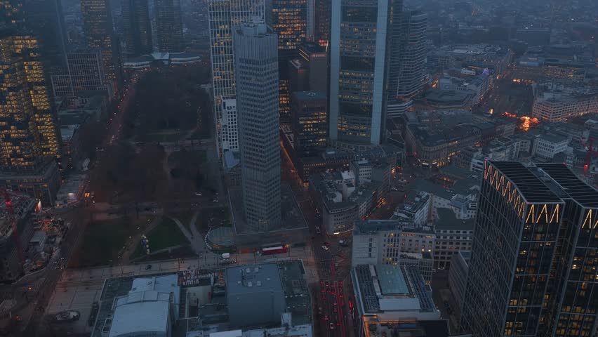 High angle view of Eurotower and skyscrapers and in foggy financial district of Frankfurt am Main, Germany, at nightfall
