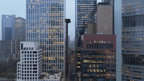 Aerial view of modern office buildings in Frankfurt financial district at dusk, revealing employees working late in illuminated offices - Powered by Shutterstock - Get 15% off with code: PIKWIZARD15
