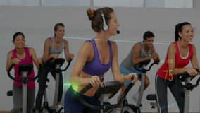 Coach leading spin class, raising arm cueing pace while ECG overlay pulsing HR or RR or SpO2 with pedals. Instructor, cycling, studio, gym, fitness, workout, cadence - Powered by Shutterstock - Get 15% off with code: PIKWIZARD15