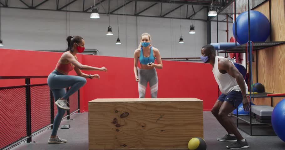 Coach signaling and counting, group doing box jumps in gym, animated mask icons showing for fitness. Plyometrics, platform, trainer, trio, explosive, balance, agility