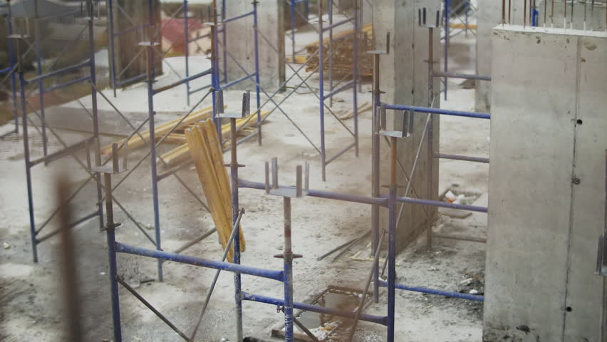 Construction site with scaffolding and concrete columns in progress