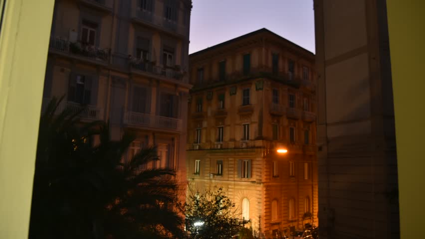Day to night timelapse showing the passage of time on a historic european building. Lights turn on as evening approaches in a classic city