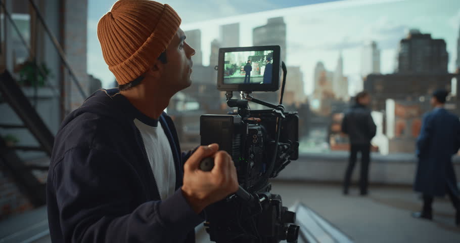 Focused Camera Operator Adjusts Cinema Rig and Framing While Filming Actors for Movie or Commercial, Cinematography Director and Crew, Using Virtual Production Technology, Cinematic Aesthetics