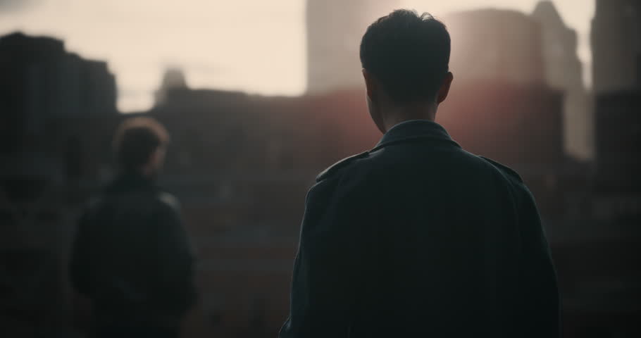 Two Male Detectives Confront Each Other on a Rooftop as a Tense Gun Standoff Escalates. Dramatic Crime Movie Mock‑up Footage for Screen Replacement. Action Scene Segment Fom a Movie