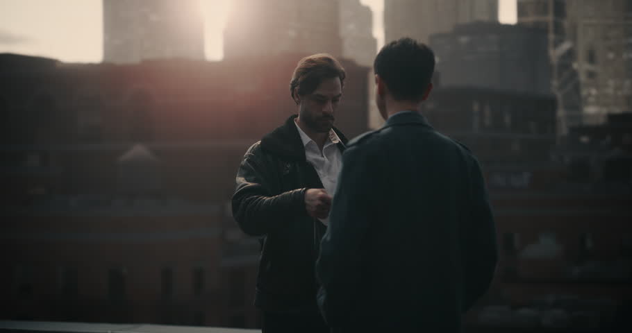 Two Male Criminals Trade a Documents on Rooftop, Then Stand Side by Side Watching the City. Cinematic Crime Sequence Mock‑up Screen Replacement, Trailer, Movie, Film, Screen Insert