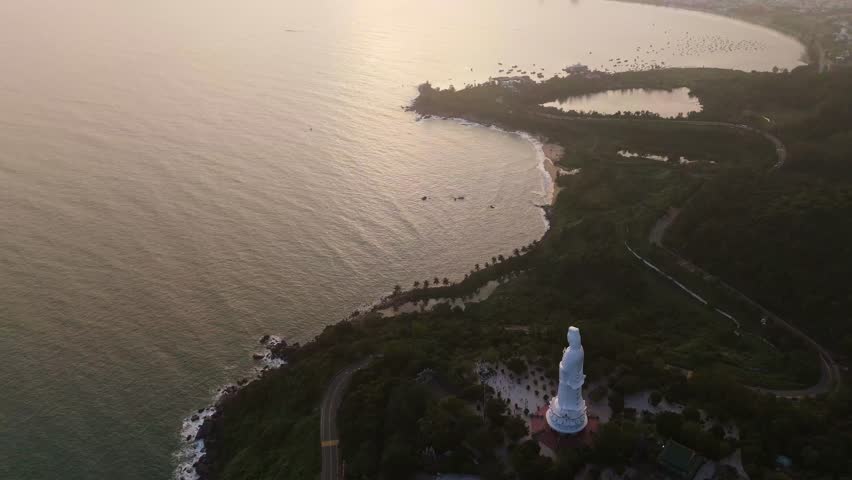 Aerial sunset Panoramic over the distant Da Nang city skyline and coastline, viewed from the Son Tra Peninsula