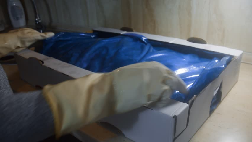 Box full of frozen chicken legs, unpacking